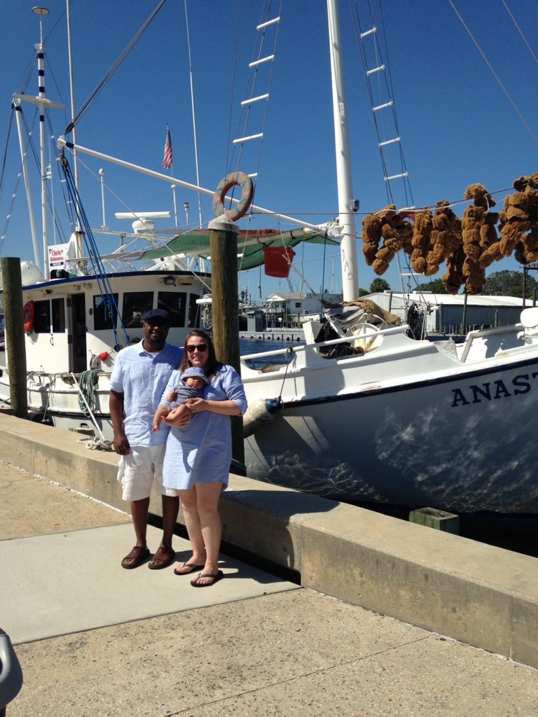 Family in front of a sponge boat