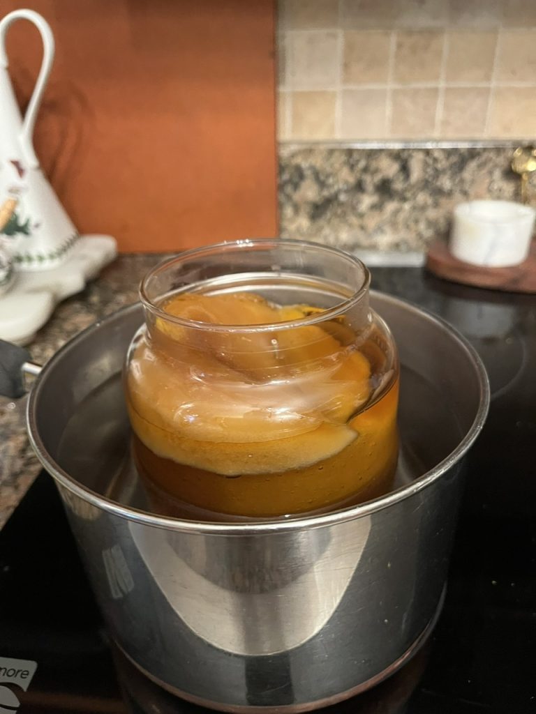 Melting the candle to even it out.